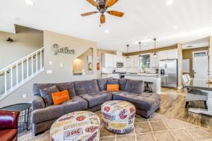 a living room with a couch and a kitchen at Driftwood Star in Lincoln City