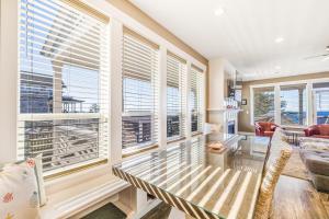 a living room with a glass table and windows at Driftwood Star in Lincoln City