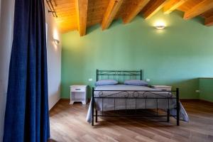 a bedroom with a bed in a green wall at IL MASCHERONE in Sepino +61 photos