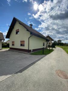 a white house with the sun in the sky at Old Traditional House in Visoko