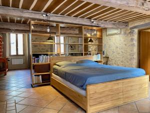 a bedroom with a bed and a book shelf at 5 Star Rated Exclusive House in Valbonne Village in Valbonne