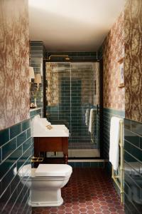 a bathroom with a toilet and a sink and a shower at Rusacks St Andrews in St. Andrews