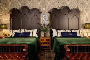a bedroom with two beds with green covers at Rusacks St Andrews in St. Andrews
