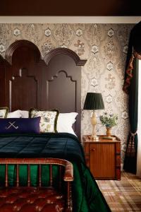 a bedroom with a bed and a table with a lamp at Rusacks St Andrews in St. Andrews