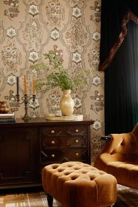 a room with a table with a vase and a chair at Rusacks St Andrews in St. Andrews