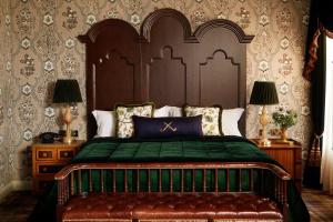 a bedroom with a bed with a green comforter at Rusacks St Andrews in St. Andrews