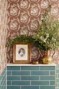 a vase with a plant on a shelf in a bathroom at Rusacks St Andrews in St. Andrews