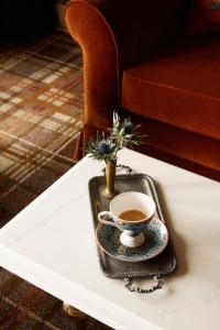 a cup of coffee on a tray on a table at Rusacks St Andrews in St. Andrews