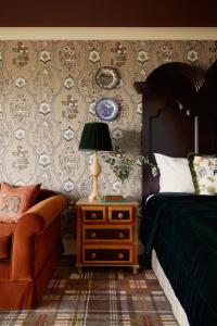 a bedroom with a bed and a table with a lamp at Rusacks St Andrews in St. Andrews