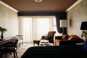 a living room with a couch and chairs in a room at Rusacks St Andrews in St. Andrews