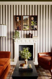 a living room with a couch and a fireplace at Rusacks St Andrews in St. Andrews