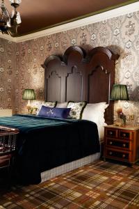 a bedroom with a large bed with a wooden headboard at Rusacks St Andrews in St. Andrews