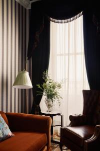 a living room with a couch and a window at Rusacks St Andrews in St. Andrews