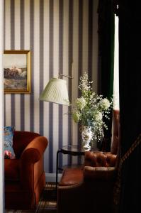 a living room with a couch and a table and a chair at Rusacks St Andrews in St. Andrews