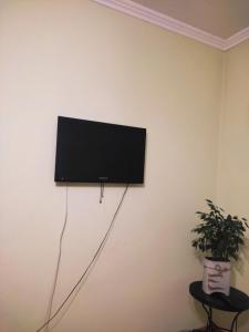 a flat screen tv hanging on a wall at Lviv's Prospekt Shevchenka Apartments in Lviv