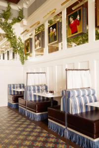 a restaurant with blue and white chairs and pictures on the wall at Rusacks St Andrews in St. Andrews