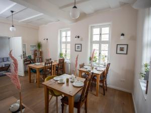 a dining room with wooden tables and chairs at Altstadthotel Treysa in Schwalmstadt