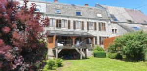 a large brick building with a porch in a yard at Le Bonheur Cristallin in Rochefort