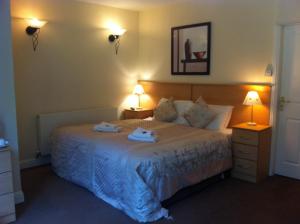 a bedroom with a bed with two towels on it at Ashling House Serviced Accommodation in Dublin