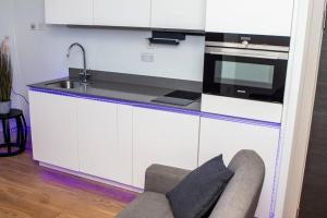 a kitchen with a sink and a microwave at Stunning 1-Bedroom flat in London! in London