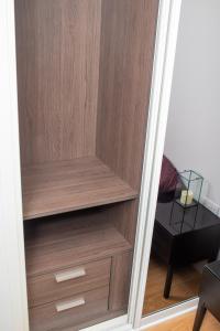 a wooden closet with wooden shelves and a table at Stunning 1-Bedroom flat in London! in London