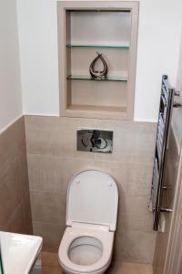 a small bathroom with a toilet and a sink at Stunning 1-Bedroom flat in London! in London