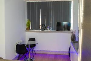 a living room with a table and a tv in a window at Stunning 1-Bedroom flat in London! in London