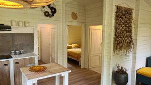 a bedroom with a bed and a table in a room at Casa Ibiza is vakantie in Drenthe in Schoonebeek +11 photos