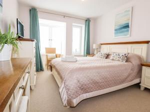 a bedroom with a bed and a large window at 16 Ocean Heights in Newquay