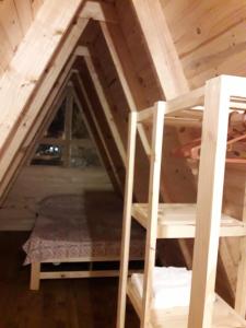 a attic with a ladder and a bunk bed at Cabañas Samay in Funes