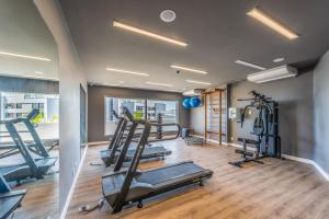 a gym with treadmills and ellipticals in a room at Novotel Salvador Rio Vermelho in Salvador