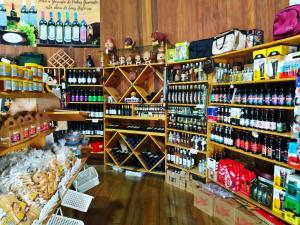 a store filled with lots of bottles of alcohol at Chalé Temático em Pipa de Vinho - Parada da Pipa Chalés in Canela