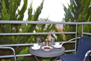 a table with a bowl of food on a balcony at Filoxenia Hotel in Volos