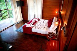 a bedroom with a bed in a room with a window at Southern Panorama Indriya Resorts & Spa in Munnar