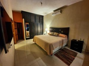 a bedroom with a large bed in a room at APARTHOTEL VISTA LAGO in Flores