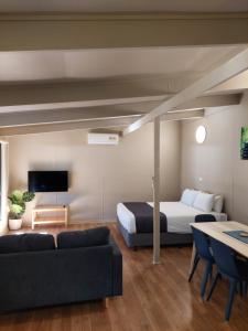 a living room with a bed and a couch at Robe Holiday Park in Robe