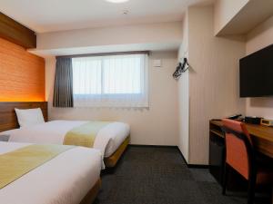 Postel nebo postele na pokoji v ubytování Hotel Wing International Takamatsu