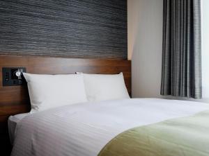 Postel nebo postele na pokoji v ubytování Hotel Wing International Takamatsu