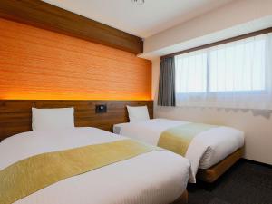 Postel nebo postele na pokoji v ubytování Hotel Wing International Takamatsu