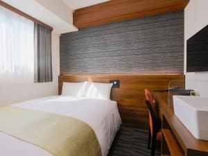 Postel nebo postele na pokoji v ubytování Hotel Wing International Takamatsu