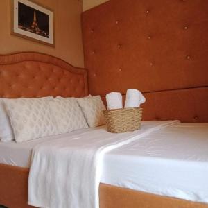 um quarto com uma cama com duas toalhas num cesto em EMSMAR 908 Wind Residences Tagaytay em Tagaytay