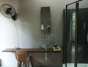 a bathroom with a glass sink and a shower at Baba pim villa in Chiang Mai