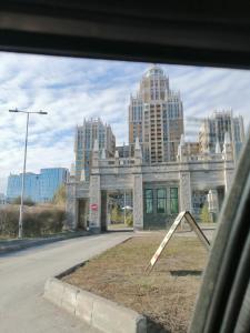 a view of a building in a city with tall buildings at Apart Hotel Триумф Астаны 22 этаж, Секция 2 in Astana