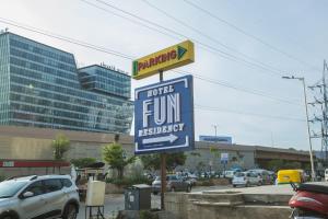 a sign for a fortune fund membership in a parking lot at Hotel Fun Residency by Antra Group in Ahmedabad