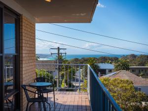 
a view from a balcony of a patio with a view of the ocean at Sheridan Court on Wagonga in Narooma
