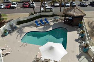 a pool with umbrellas on top of it at Chateau Royale Beach Resort in Maroochydore