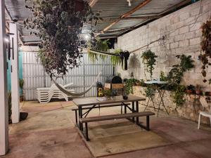 a picnic table in a greenhouse with plants at APARTHOTEL VISTA LAGO in Flores