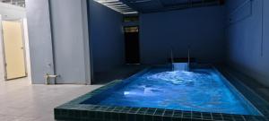 a large blue bath tub in a blue room at JMA FERRINGHI BEACH HOTEL in Batu Ferringhi