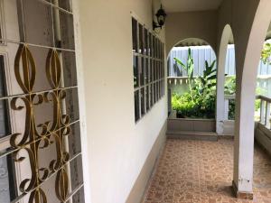a hallway of a house with a wrought iron gate at AbgZul Homestay in Kota Bharu