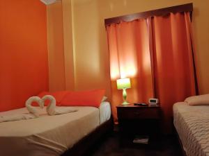 Postel nebo postele na pokoji v ubytování Boquete Town Hostal